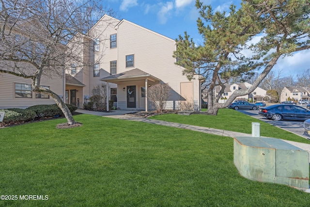 view of front of house with a front yard and a residential view