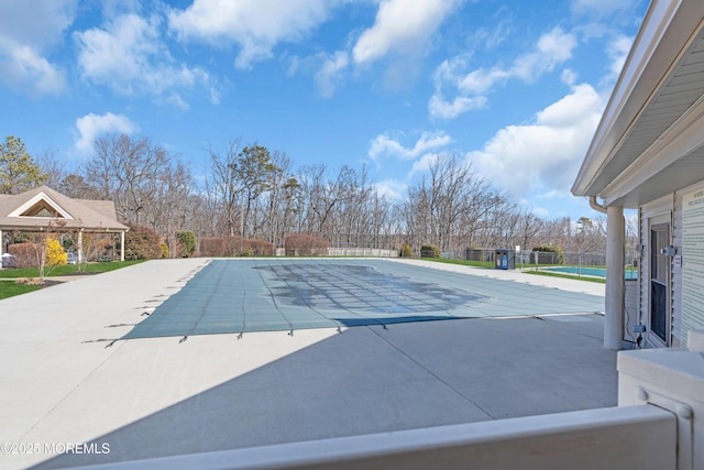 view of swimming pool featuring a patio area, fence, and a fenced in pool