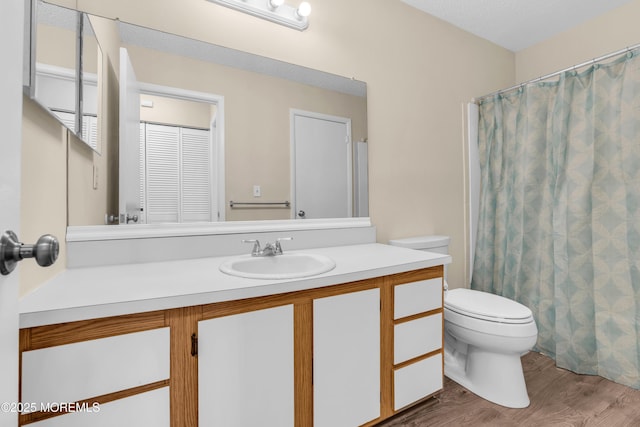 full bathroom with toilet, wood finished floors, vanity, and a shower with curtain