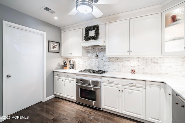 kitchen with visible vents, decorative backsplash, stainless steel appliances, light countertops, and white cabinetry