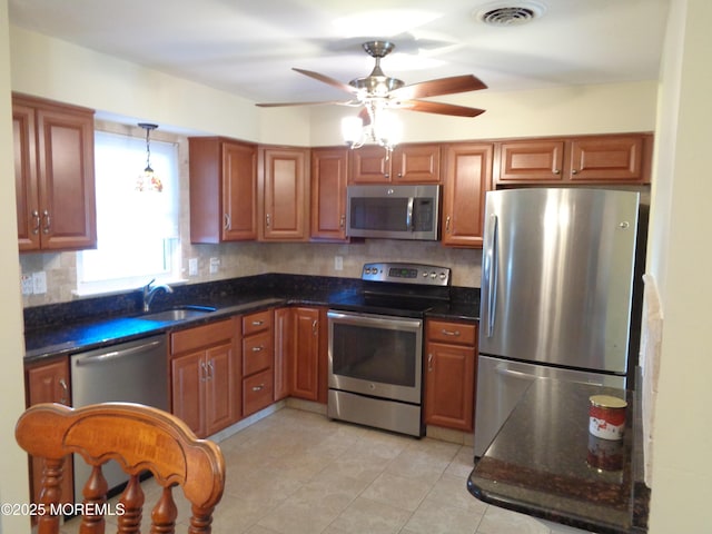 kitchen with stainless steel appliances, tasteful backsplash, visible vents, light tile patterned flooring, and a sink