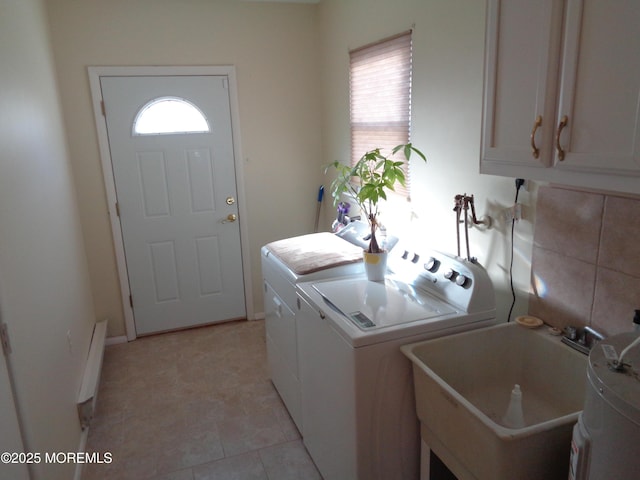 washroom featuring washing machine and dryer, cabinet space, and a sink