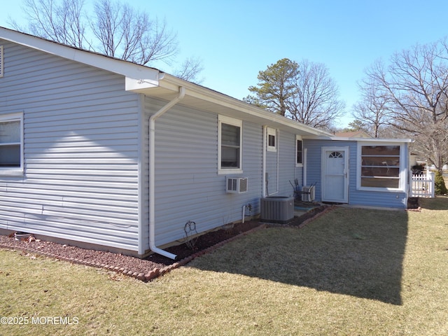 back of property with a yard and central AC unit