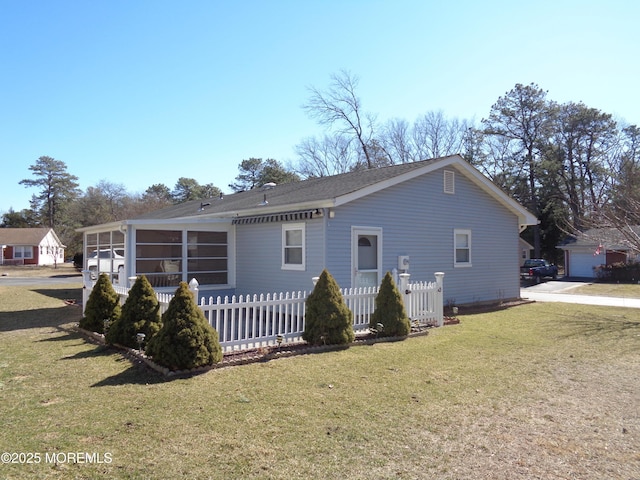 exterior space featuring a front yard, a sunroom, and fence