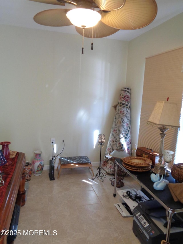 workout room with tile patterned flooring and baseboards