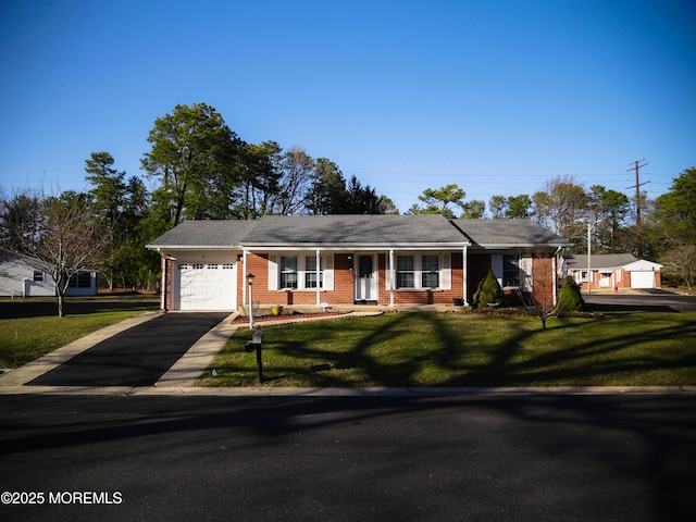 ranch-style house with aphalt driveway, an attached garage, a front yard, and brick siding