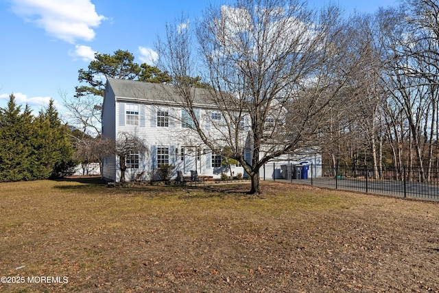 view of front of home with a front yard and fence