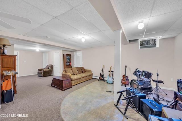 living area with a drop ceiling, baseboards, and carpet