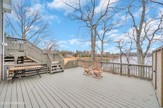 wooden terrace with stairway and a water view