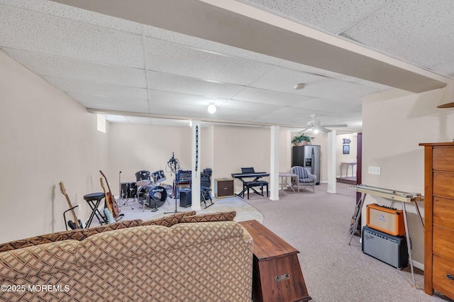 carpeted living room featuring a paneled ceiling and ceiling fan