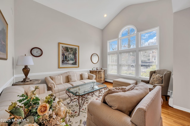 living room with high vaulted ceiling, light wood-type flooring, baseboards, and a baseboard radiator