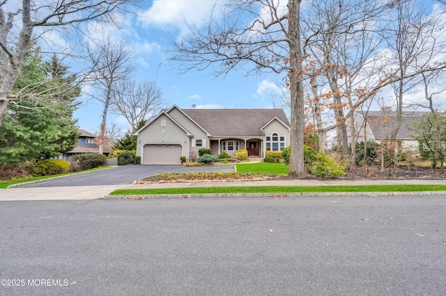 view of front facade with aphalt driveway and a garage