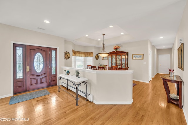 entrance foyer with visible vents, baseboards, recessed lighting, light wood-style floors, and baseboard heating