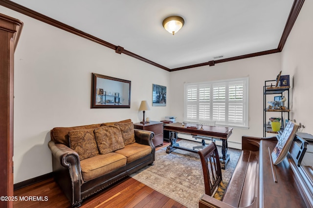 office featuring baseboards, wood finished floors, and crown molding