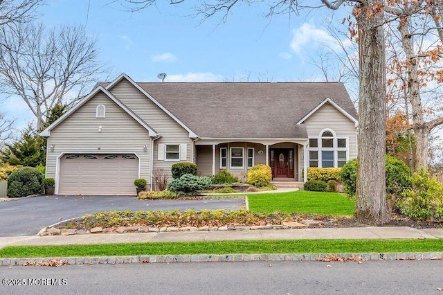 view of front of property with aphalt driveway and an attached garage