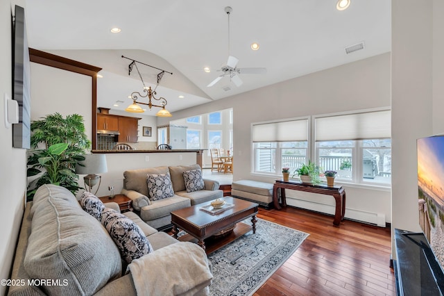 living area with visible vents, a baseboard heating unit, hardwood / wood-style floors, recessed lighting, and ceiling fan