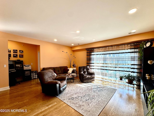 living area featuring wood finished floors, visible vents, and recessed lighting