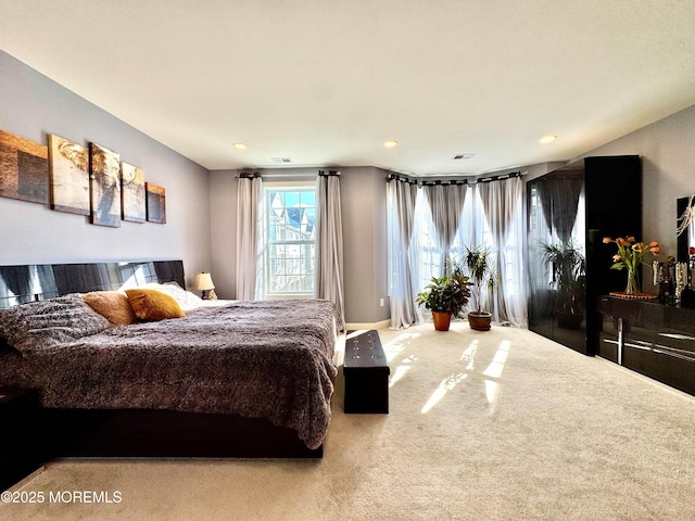 carpeted bedroom featuring visible vents