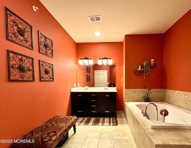 full bath featuring double vanity, visible vents, a sink, a bath, and tile patterned floors