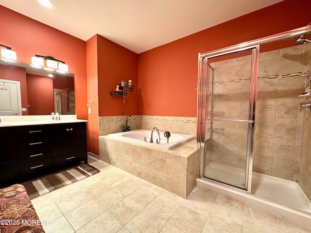 full bathroom with a stall shower, tile patterned flooring, vanity, and a bath