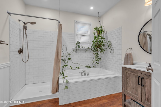 full bath featuring a tile shower, wood finished floors, a garden tub, and vanity