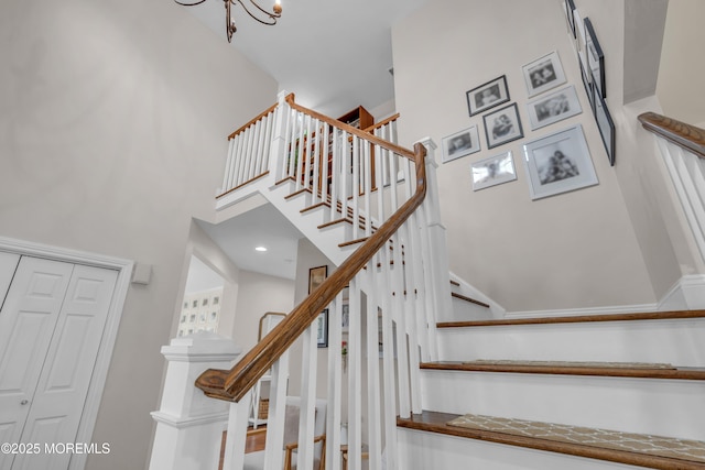 staircase featuring a towering ceiling