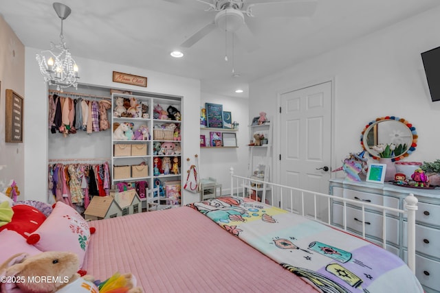 bedroom featuring ceiling fan with notable chandelier and recessed lighting