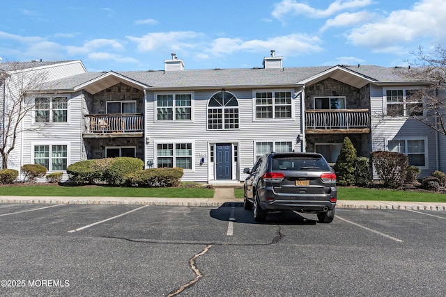 view of property with uncovered parking