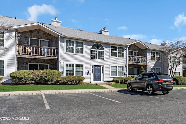 view of building exterior featuring uncovered parking