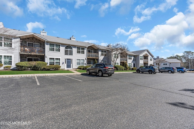 uncovered parking lot with a residential view