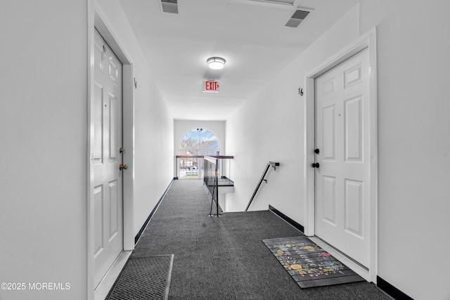 corridor featuring carpet, baseboards, visible vents, and an upstairs landing