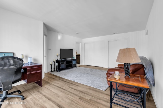 home office featuring wood finished floors and visible vents