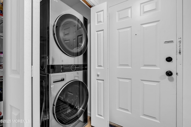 laundry area with stacked washer / dryer and laundry area