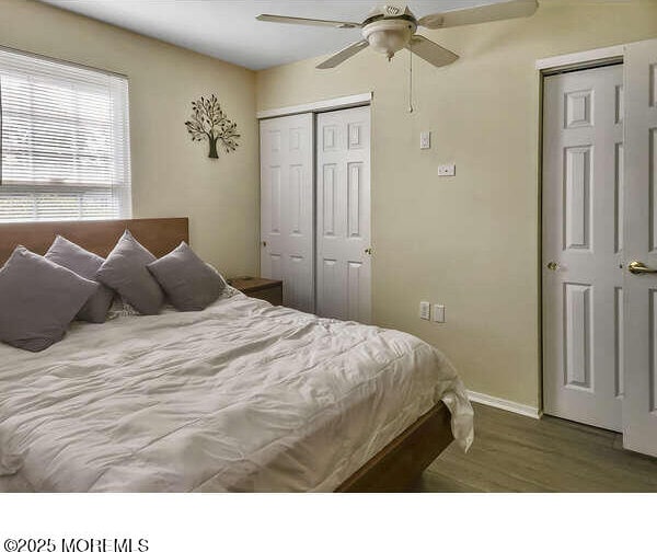 bedroom with a ceiling fan, a closet, baseboards, and wood finished floors