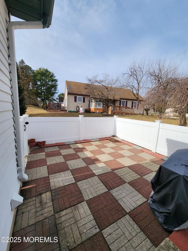 view of patio / terrace with fence private yard and a grill