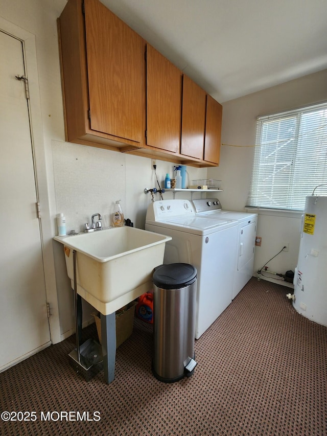 laundry room with water heater, cabinet space, and washer and clothes dryer