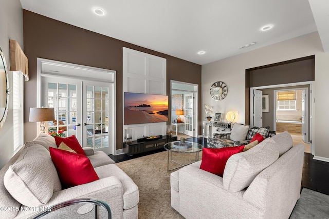living area with recessed lighting, french doors, baseboards, and wood finished floors