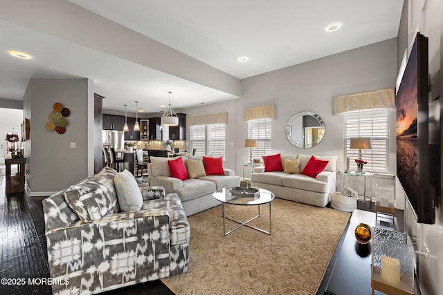 living area featuring recessed lighting, wood finished floors, and baseboards