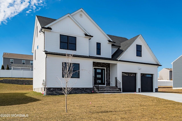 modern farmhouse style home featuring a front lawn, fence, a garage, and driveway