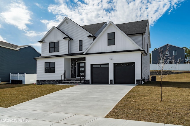 modern farmhouse with a front lawn, concrete driveway, central AC, and fence