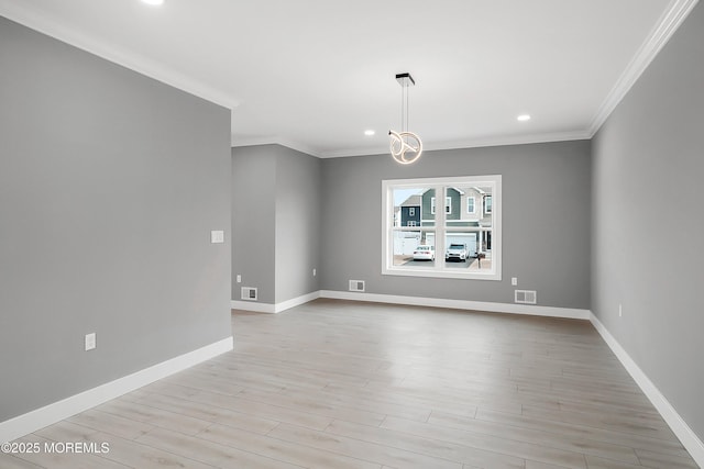 empty room with visible vents, recessed lighting, light wood-style floors, crown molding, and baseboards