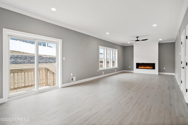 unfurnished living room with baseboards, a fireplace, ceiling fan, ornamental molding, and light wood-style floors