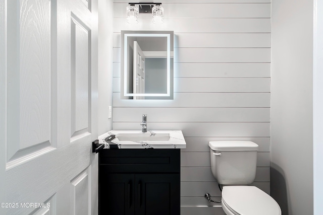 bathroom featuring toilet and vanity