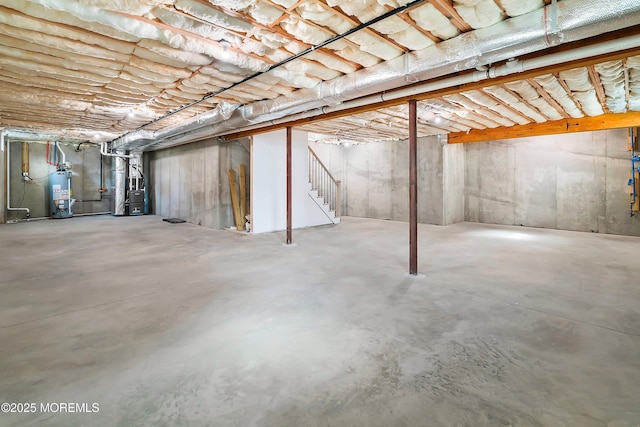 unfinished basement featuring water heater and heating unit