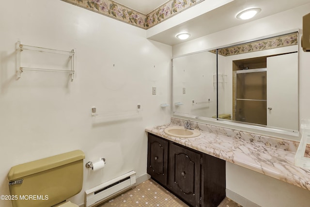 bathroom with vanity, baseboards, a baseboard heating unit, toilet, and a shower with door