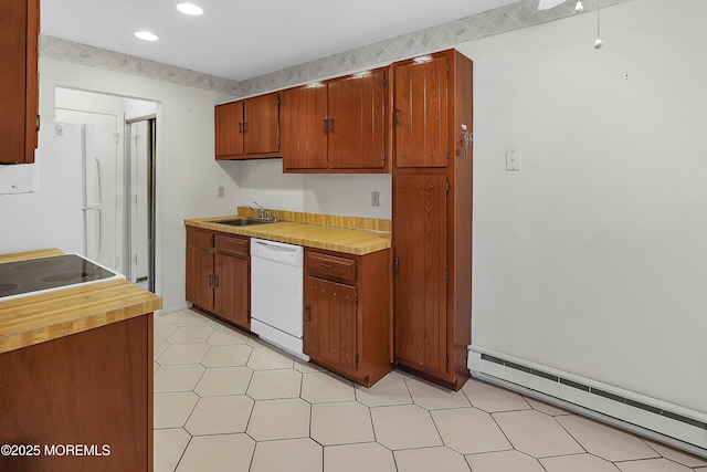 kitchen with brown cabinets, a sink, recessed lighting, white appliances, and baseboard heating