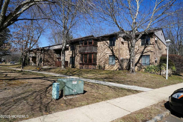 view of front of property featuring brick siding and stone siding