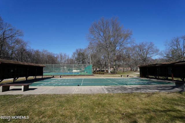 view of pool featuring a yard, shuffleboard, and fence