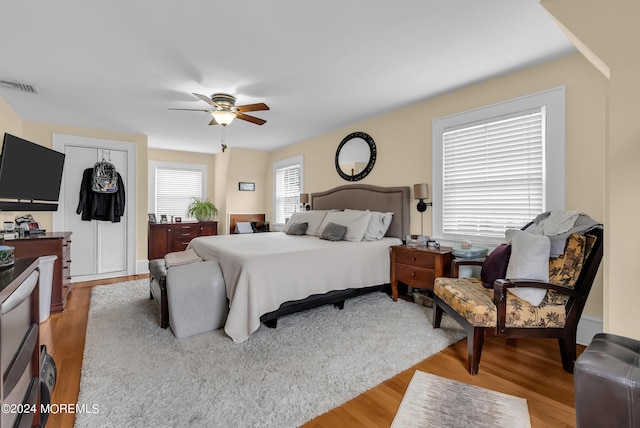 bedroom featuring ceiling fan, light wood-type flooring, and visible vents