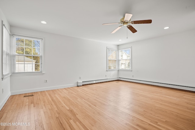 unfurnished room with recessed lighting, a healthy amount of sunlight, visible vents, and wood finished floors